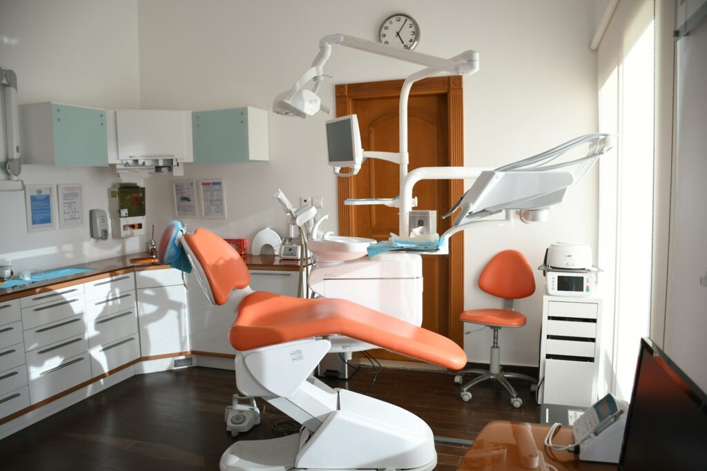 A dental chair in a sunlit treatment room