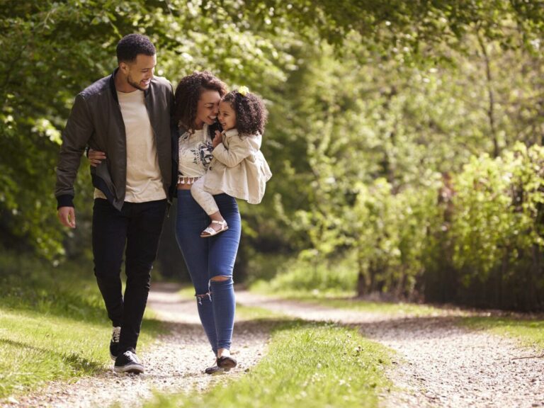 A smiling family walking together outdoors